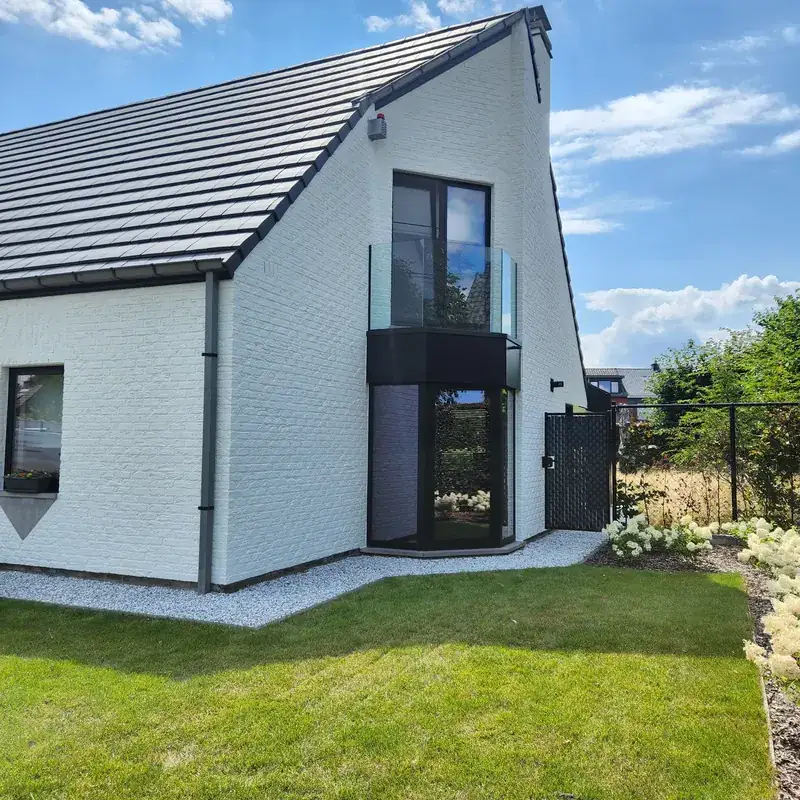 Witte woning met geschilderde gevel en balkon